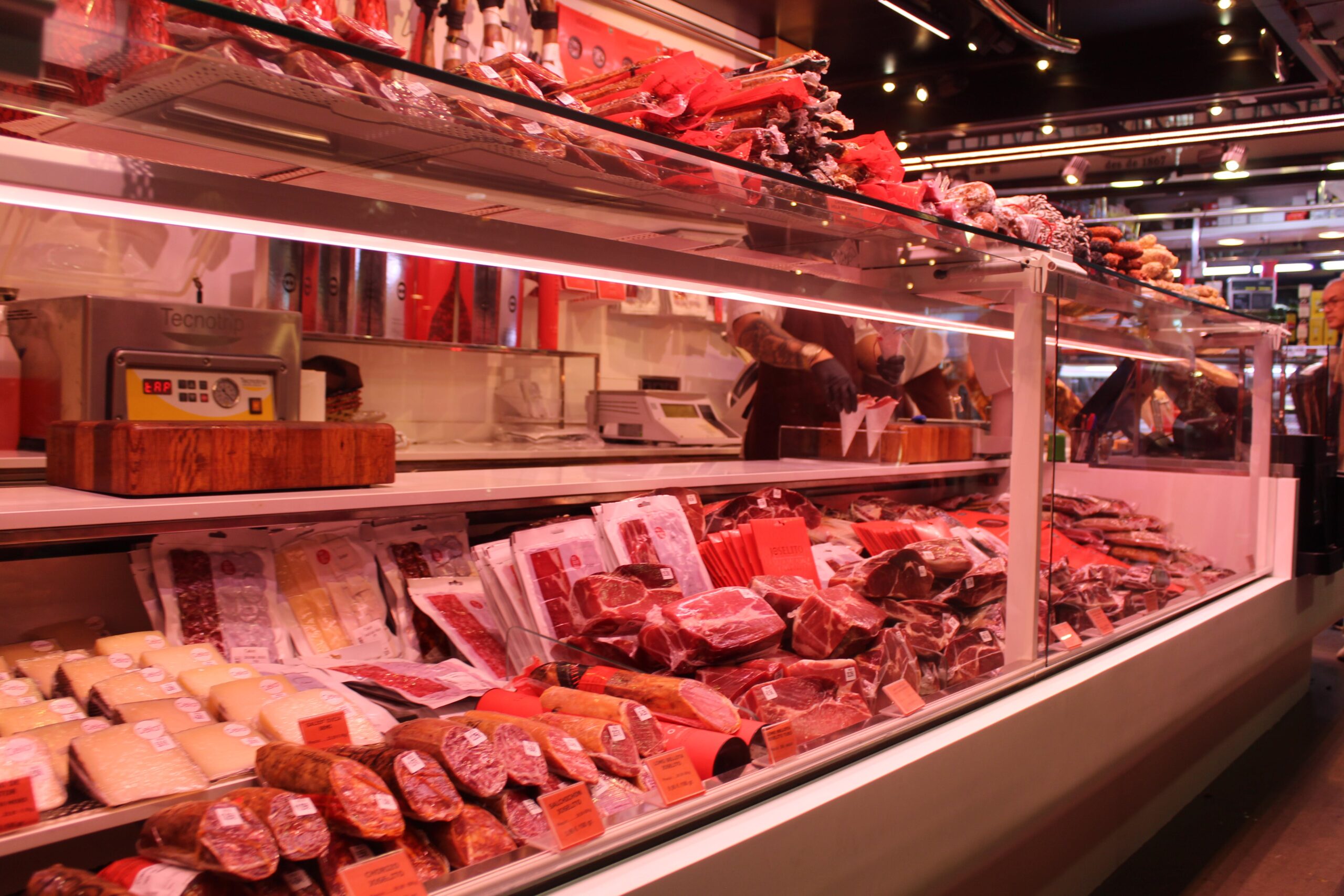 meat counter in a grocery store showing raw beef and pork cuts