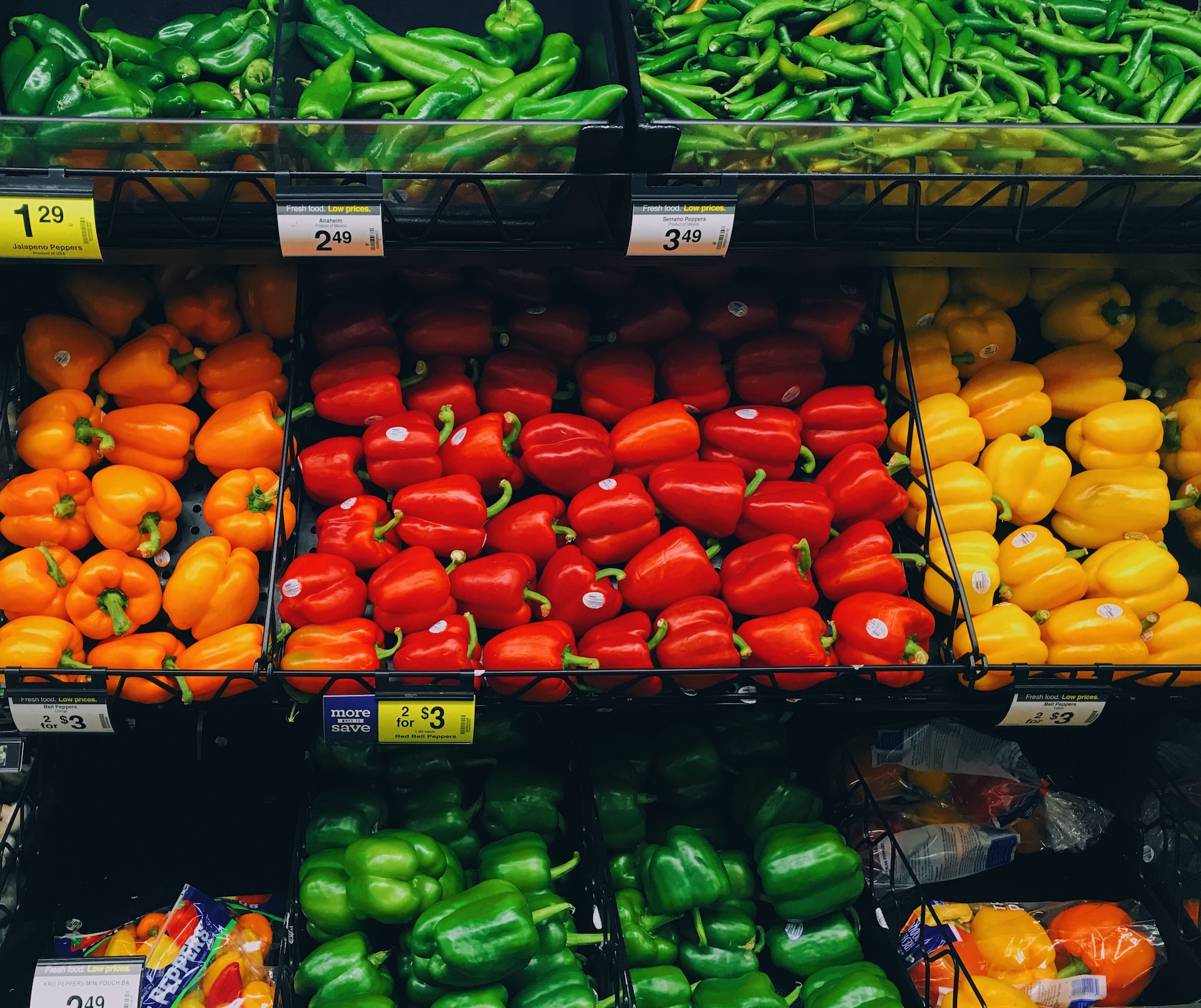 produce section in a Kroger showing bell peppers in different colors
